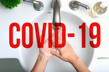 COVID-19 Coronavirus theme with person washing their hands with soap and water