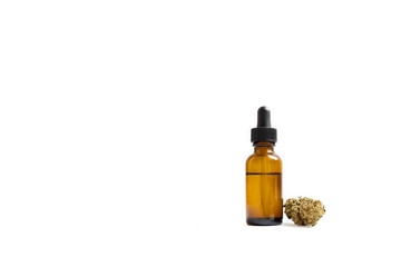 Cannabis oil in glass bottle and marijuana bud isolated on white background