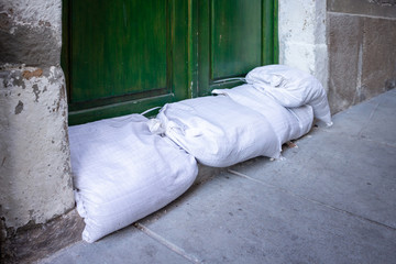 Sandbags stacked in front of doors to protect against flooding of river or sea.
