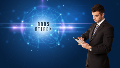 Businessman thinking about security solutions with DDOS ATTACK inscription