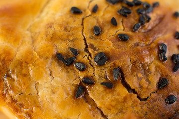 Samsa in black plastic box on wooden background.