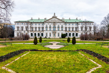 Obraz premium Warsaw, Poland Krasinski palace with park garden green grass in winter of Warszawa cloudy day exterior facade architecture view
