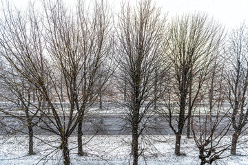 Rivne, Ukraine Rovno city in western Ukraine in winter with snow weather with sidewalk path and empty road landscape high angle view through apartment window