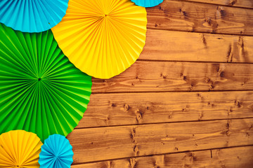 junior school children hand made decoration element origami paper yellow green blue color on wooden...