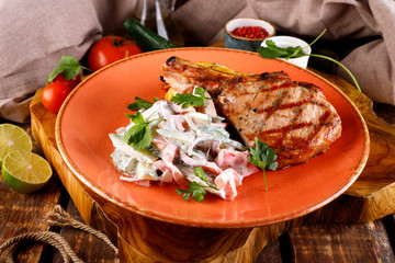 Roast pork loin served with vegetables in sauce