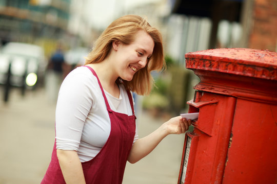 young woman posting a letter