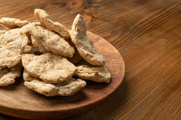 Raw Dehydrated Soy Meat or Soya Chunks on Wood Background