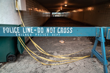 Close up of a Chicago Police line that has white lettering saying do not cross painted on blue...