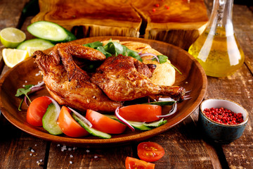 fried chicken with vegetables and bread on a plate