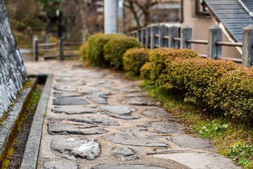 Stone paved path in Takayama, Japan at Higashiyama walking course in historic city in Gifu...