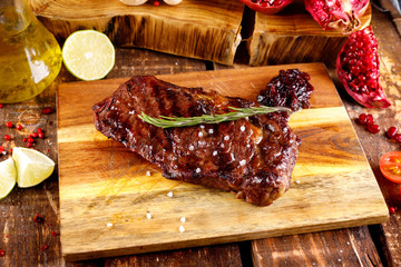 rib eye steak with margarine on a cutting Board