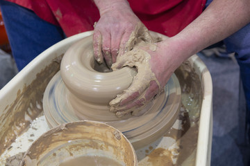 Top view of potter to make ceramic pot on the pottery wheel