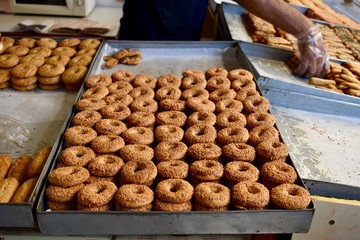 Shopkeeper is preparing orders of fresh baked cookies