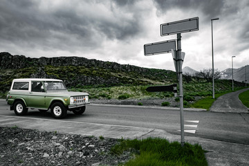 Green SUV eats on empty road