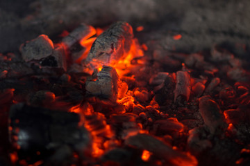 Glowing red hot coals of fire in a home fireplace