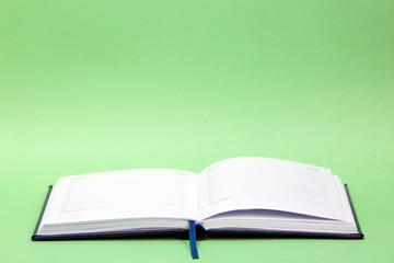 Open diary on a colored background
