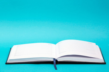 Open diary on a colored background
