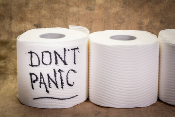 do not panic message - handwriting on a roll of a toilet paper,