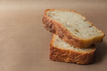 Homemade rye-wheat yeast-free bread made from live sourdough. Two slices of rye-wheat bread with flax and sunflower seeds close-up on a beige linen tablecloth from Kopi space