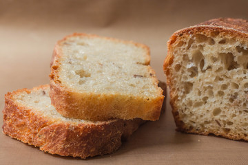 Homemade rye-wheat yeast-free bread made from live sourdough. Two slices of rye-wheat bread with flax and sunflower seeds close-up on a beige linen tablecloth from Kopi space
