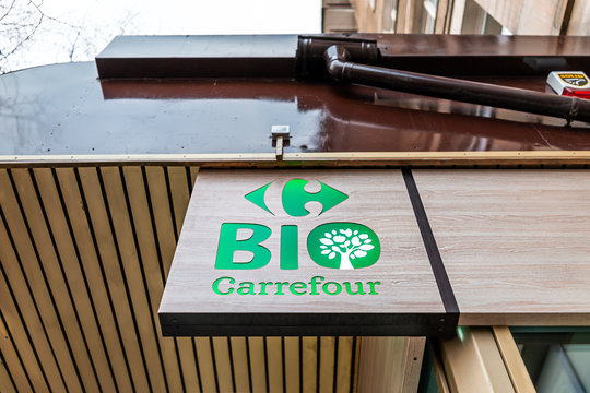 Warsaw, Poland - January 22, 2019: Storefront sign for Carrefour bio organic green grocery supermarket on street in downtown center low angle closeup view
