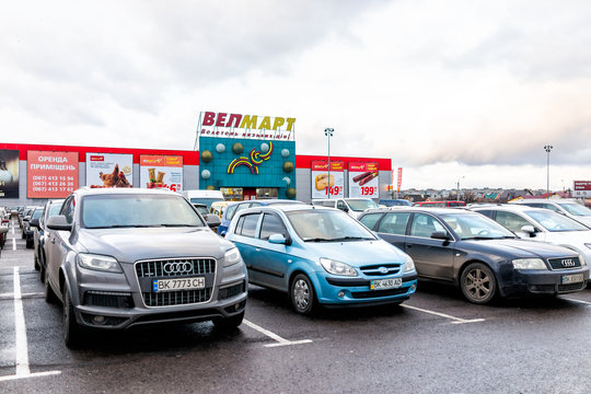 Rivne, Ukraine - January 4, 2020: Western Ukrainian Rovno city with parking lot and sign for Velmart or Welmart grocery store in famous Ekvator shopping mall center in downtown