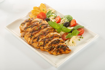 Italian style marinated chicken breast with fresh salads and tomato catchup on a white rectangle plate