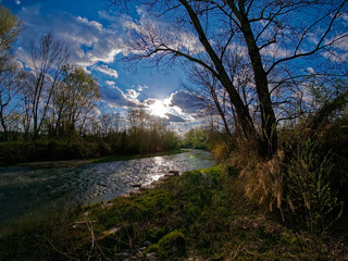The sky, the sun, the clouds, the river and the forest