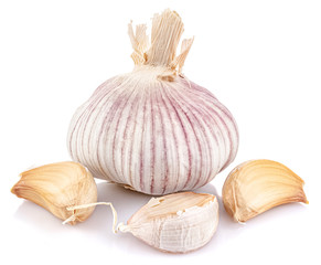 Garlic cloves against whole garlic head isolated on white background with reflection on glossy surface