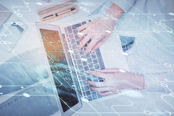 Double exposure of woman hands working on computer and data theme hologram drawing. Top View. Technology concept.