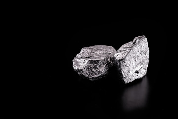silver nugget native to Liberia isolated on black background.