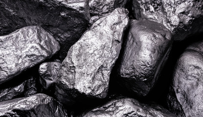 Raw manganese. Manganese stone isolated on black background. Mineral extraction of heavy metals...