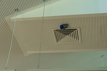 White sound absorption ceiling with duct grilles and lights