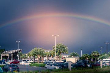 The well known Bagatelle shopping mall in Mauritius under a beautiful rainbow on an overcast day