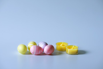 Easter colorful eggs and yellow candle.