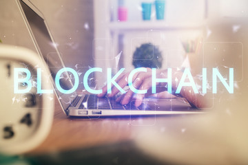 Double exposure of woman hands typing on computer and crypto market theme hologram drawing....