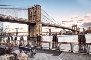 Brooklyn Bridge and Manhattan bridge view with New York City skyline from East River promenade