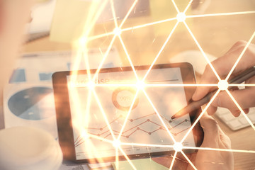 Double exposure of man's hands holding and using a phone and social network theme drawing.