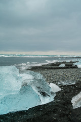 Diamond beach on Iceland or Jokulsarlon Iceberg beach. Crystal ice melting on volcanic beach In Iceland.
