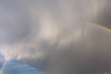 Thundercloud and rainbow over the city