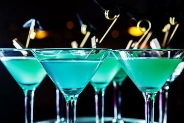 Glasses with cool turquoise cocktails