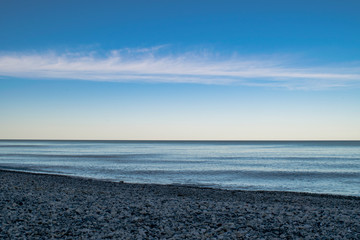 Lake Michigan with a colorful sun set and a stony beach foreground - Milwaukee, Wisconsin USA