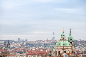 Fototapeta premium Panorama of Prague, Czech Republic, seen from above, during an autumn cloudy afternoon. Major tourist landmarks such as Zizkov TV Tower and Kostel Svateho Mikulase church and cathedrals are visible