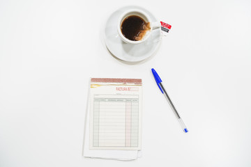 Hands with office supplies on work table with pen, tea and writing paper and decoration with sunglasses on the table.