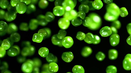 Fresh green peas exploding. Shot with high speed cinematic camera. Super slow Motion.