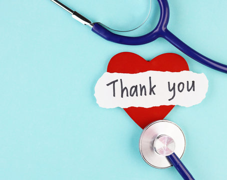 medical stethoscope, healthy red heart and the inscription Thank you on a blue background