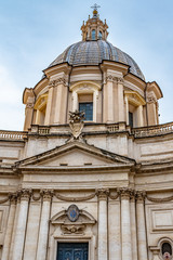 Rome, Italy. Sant Agnesse in Agone baroque Church in Piazza Navona Square behind Fontana dei Quattro Fiumi (Fountain of Four Rivers) monument. Vintage Italian/ Roman/ European art and architecture.