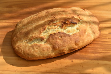 freshly baked bread on wooden cutting board isolated