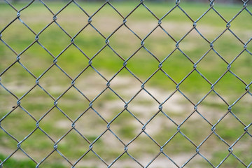 Naklejka premium Fence Pattern with Field and Grass in the Background