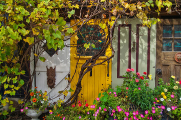 Red, yellow, white and brown vintage wooden doors used for decoration in Elora township, Ontario, Canada